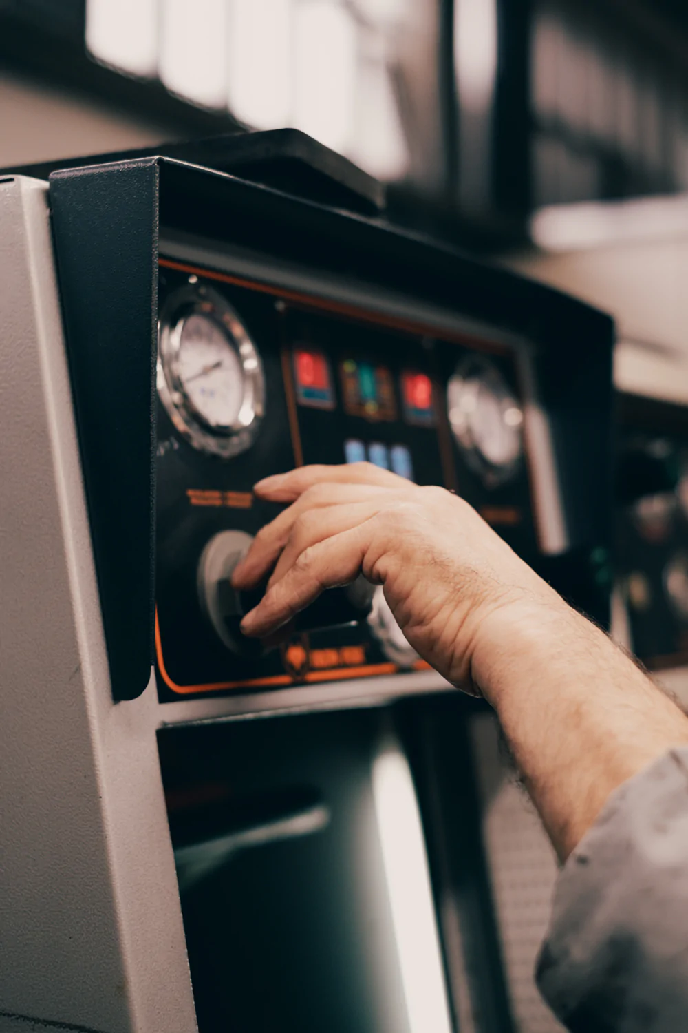 A man is using a machine in a factory.