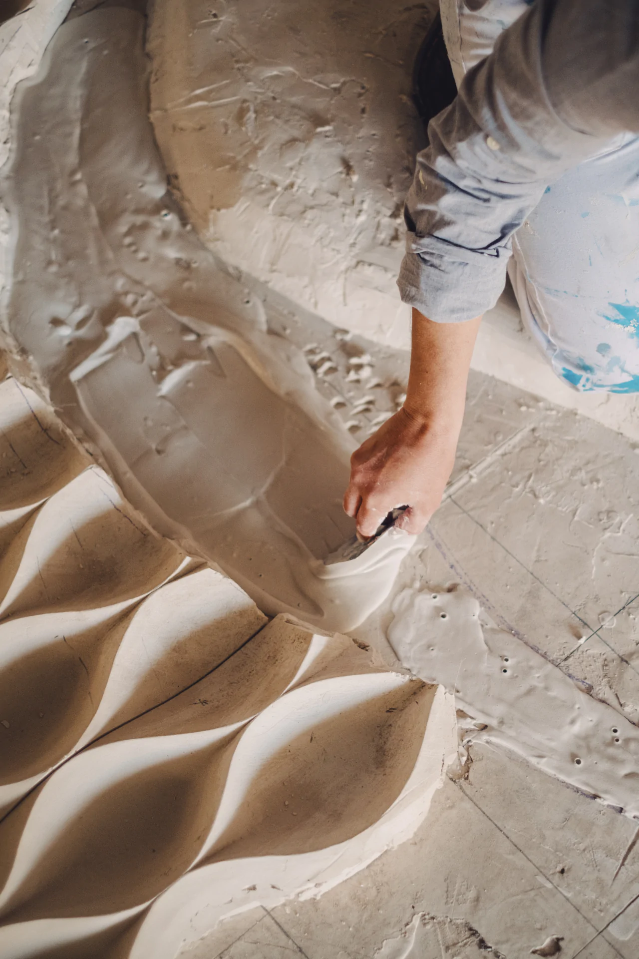 A person is working on a piece of art.