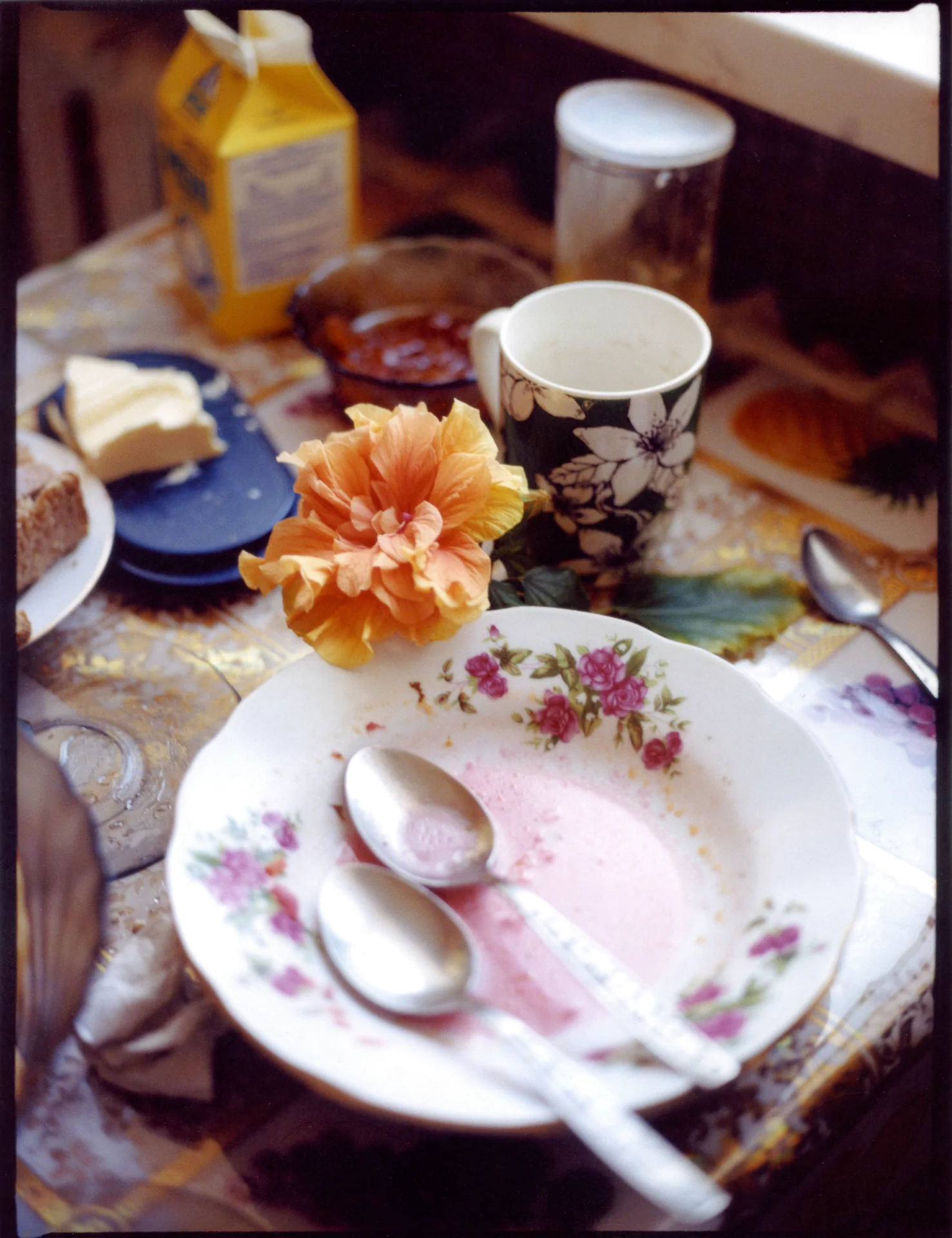 A plate of food on a table with spoons and utensils.