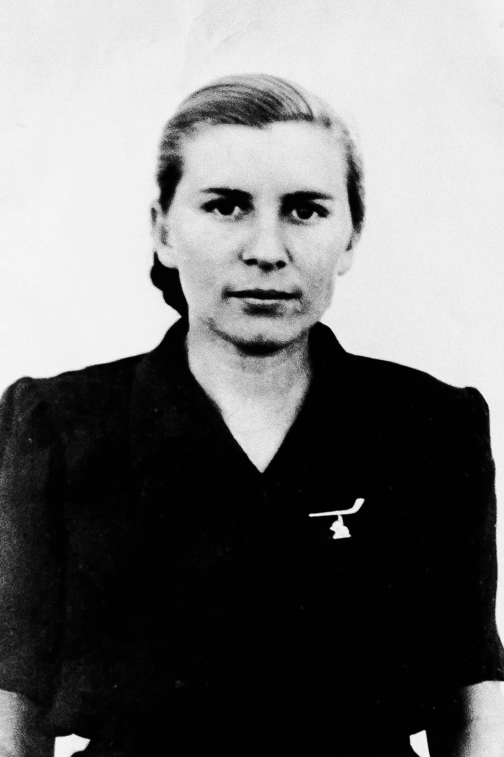 A black and white photo of a woman in a black shirt.