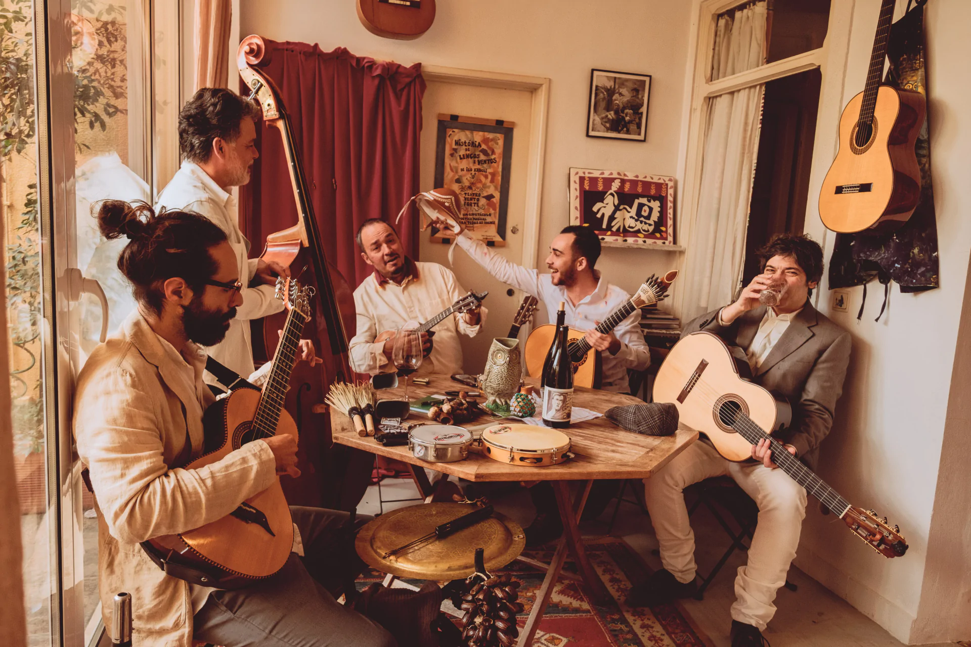 A group of men playing guitars in a room.