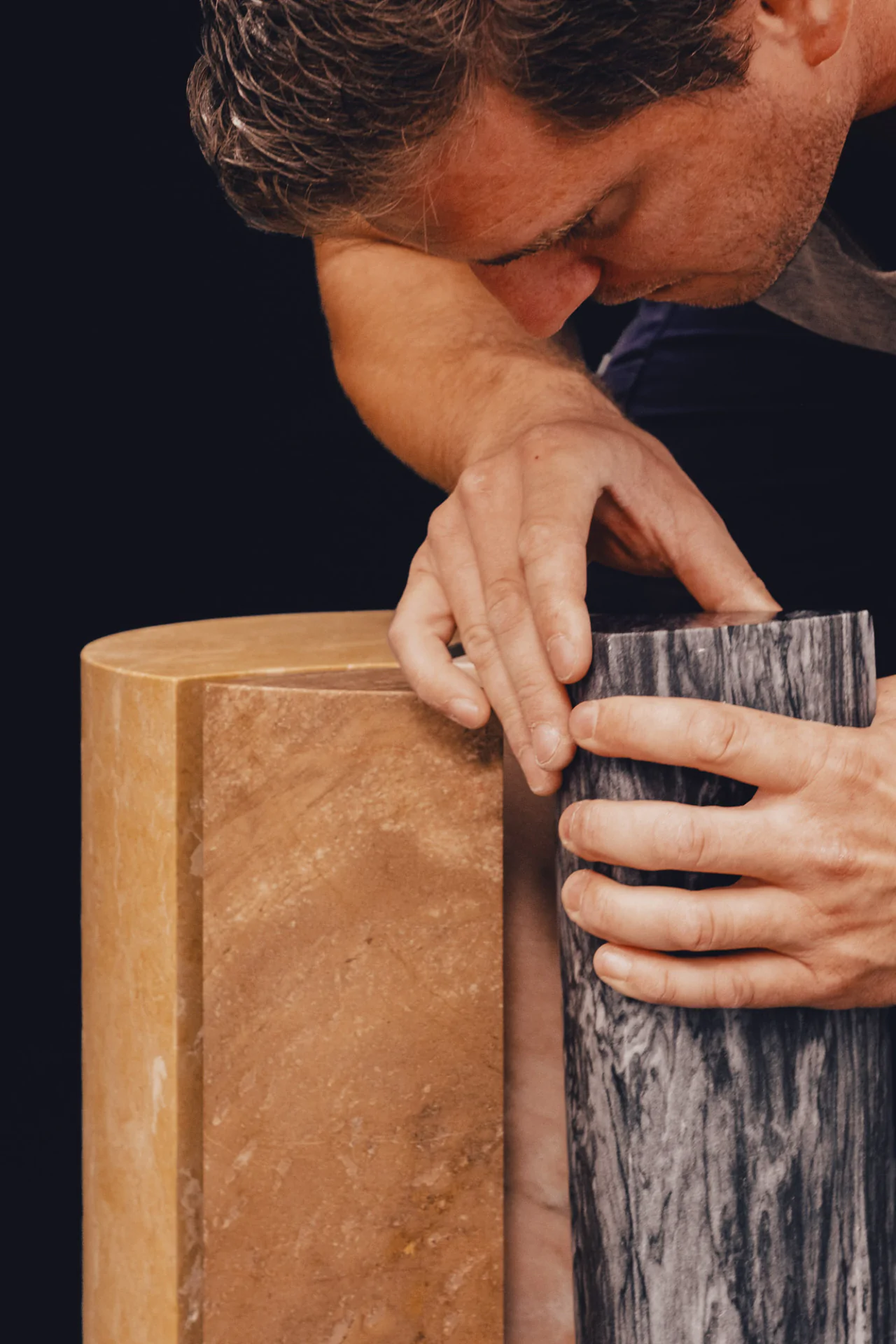 Three varied marble types representing the gold, rose gold and white gold of Cartier's Trinity Ring in Sebastian Herkner's commemorative table design