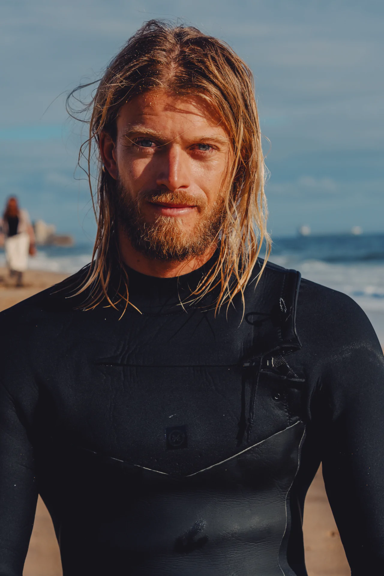 Surfer portrait with wet hair and wetsuit Portuguese coast Airbnb Experiences