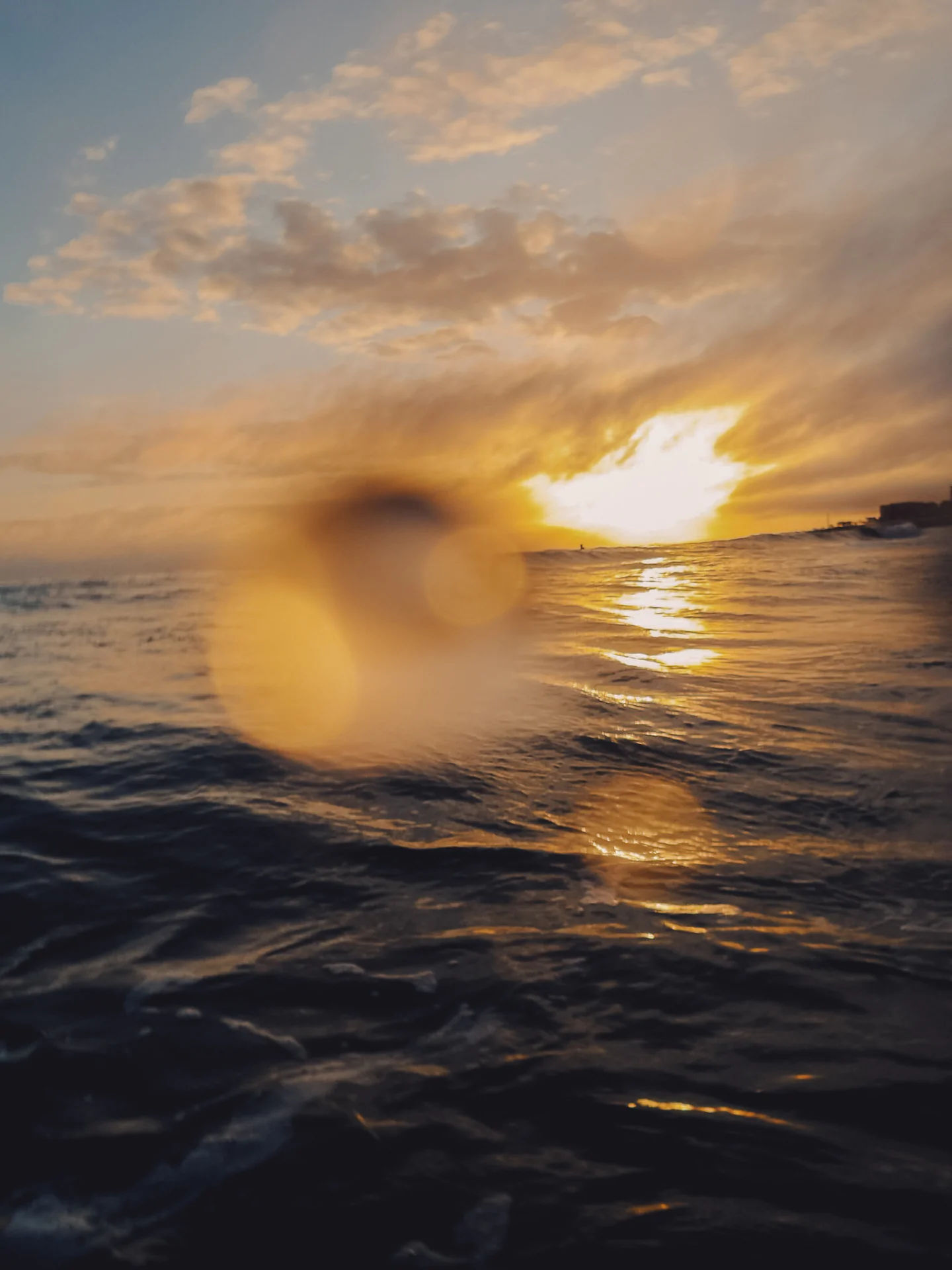 Blurred sunset over ocean through water drops Portugal surf photography