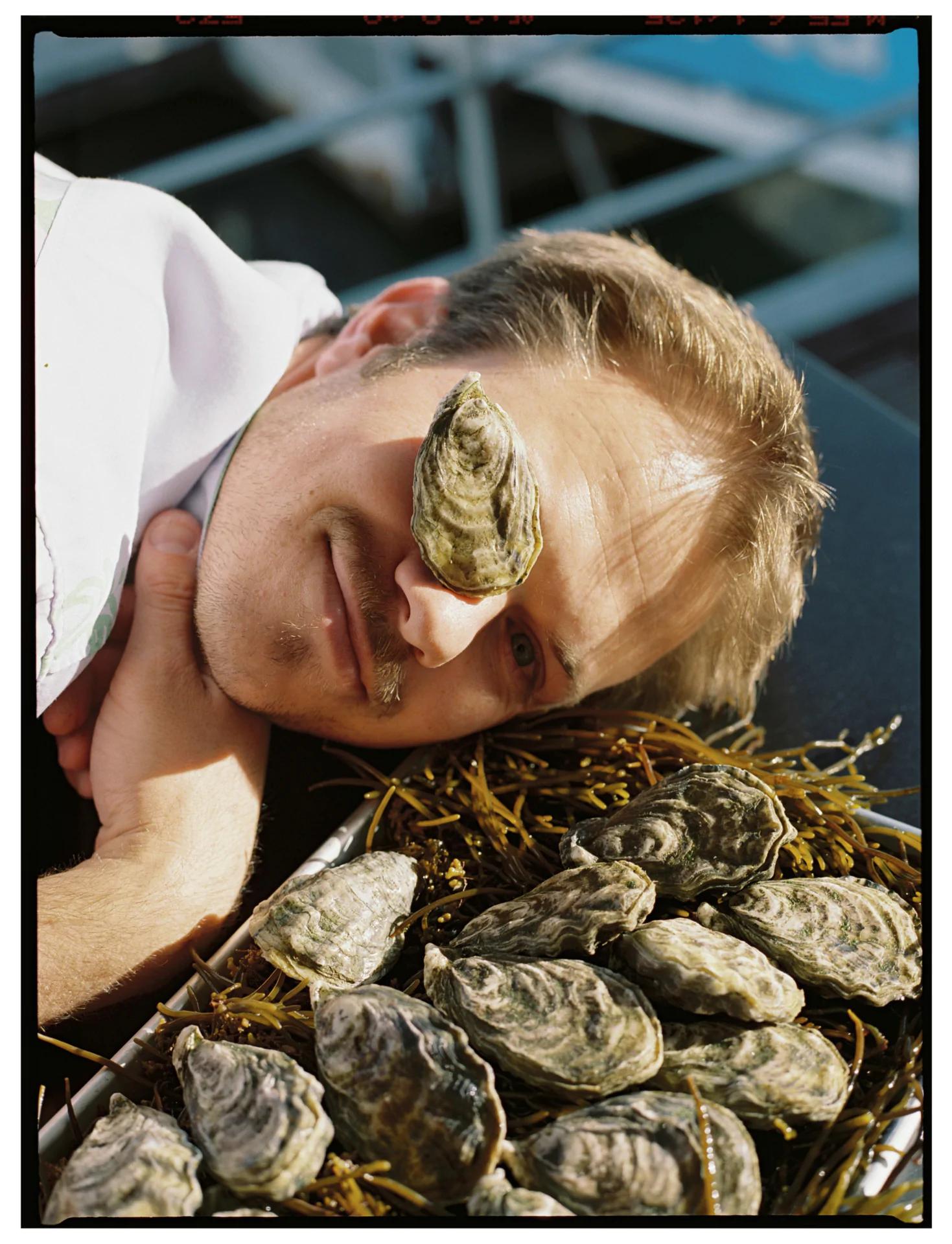 Person holding oyster over eye with seaweed Lisbon Portugal Airbnb campaign