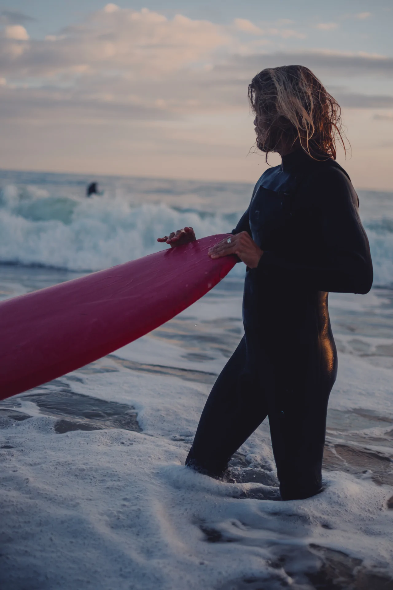 man with surfboard silhouette walking into ocean sunset Portugal