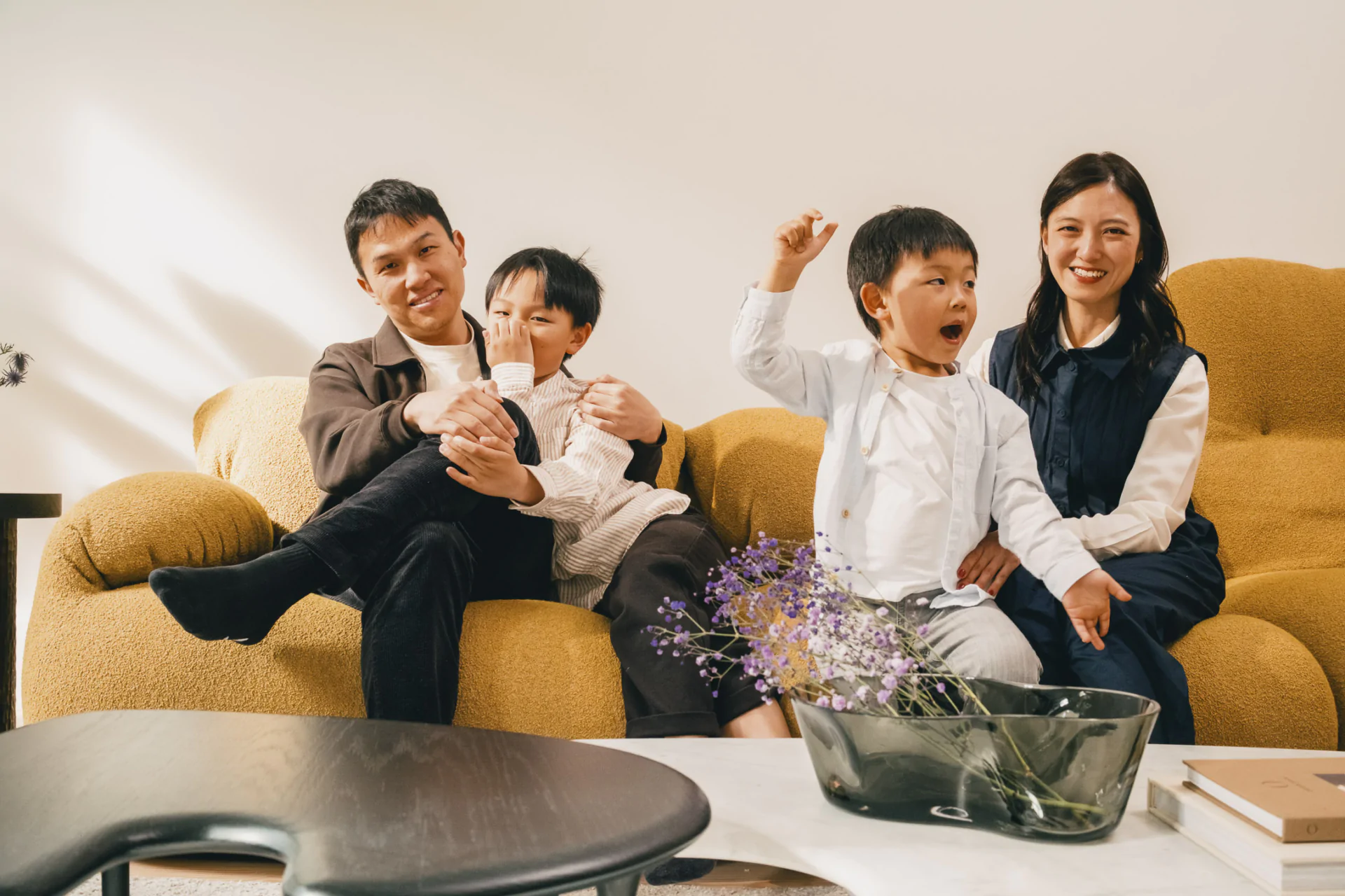 Gabriel Tan and Cherie with children on Herman Miller sofa, Porto